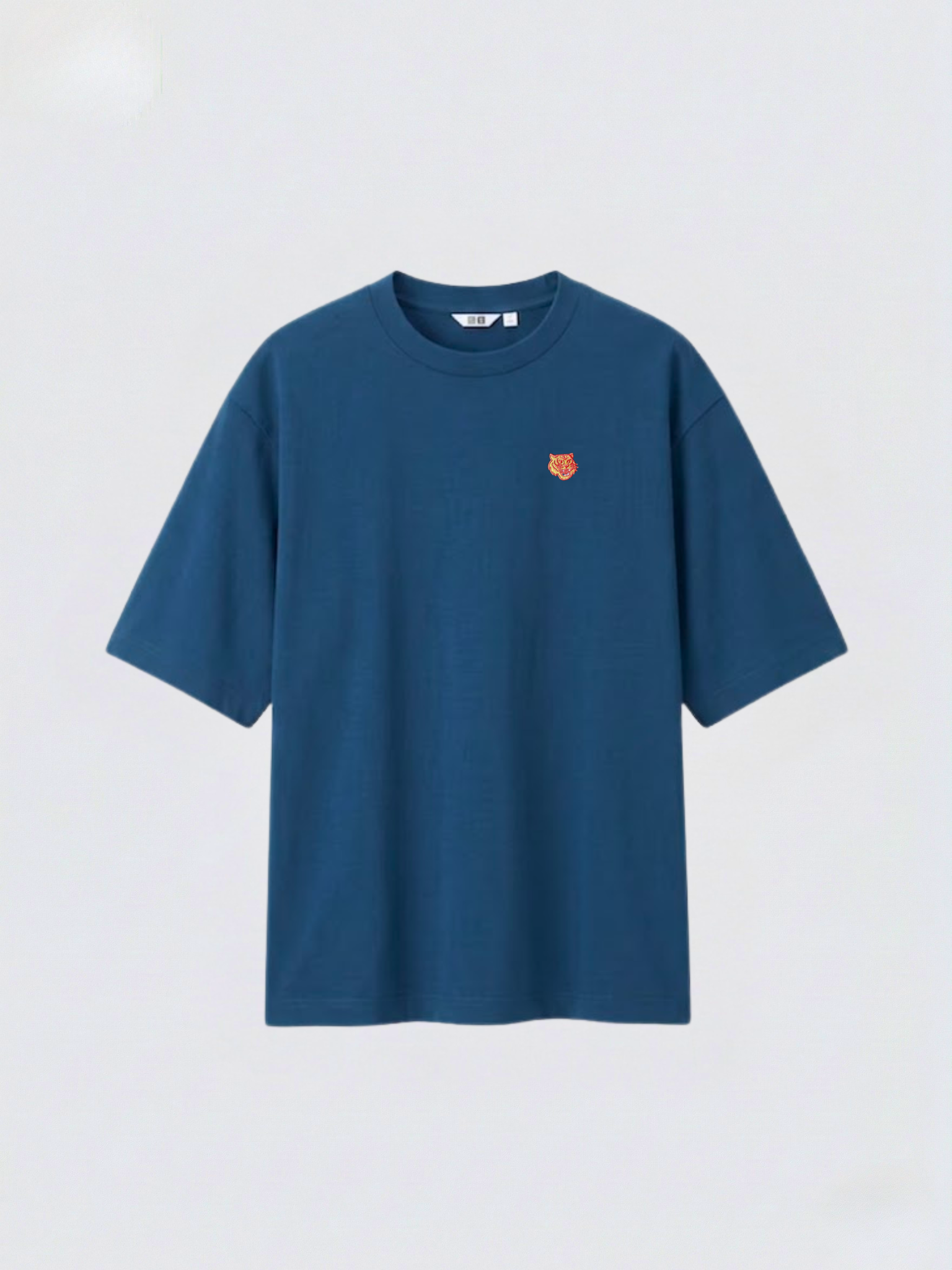 Marine Blue_oversized_boxy_tee_with_1.5_inch_embroidered_tiger_face_icon_logo_by_studio_tigre_on_a_premium_uniqlo_airism_tee on a white background