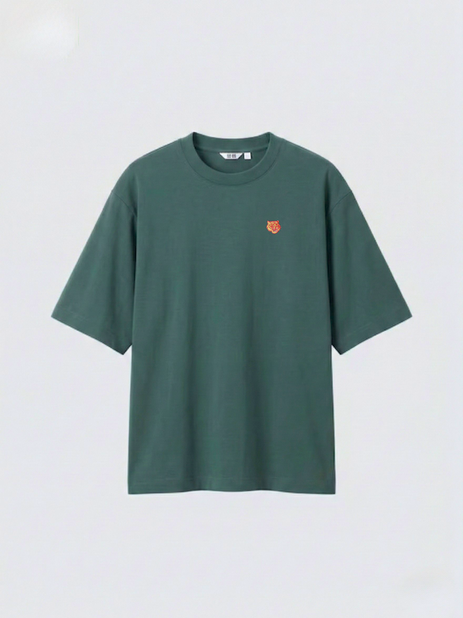 dark_green_oversized_boxy_tee_with_1.5_inch_embroidered_tiger_face_icon_logo_by_studio_tigre_on_a_premium_uniqlo_airism_tee on a white background